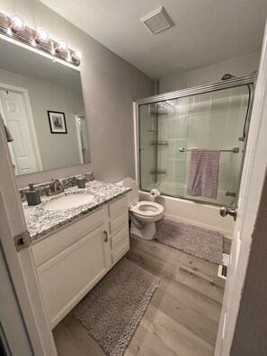 Combined shower/tub, hair dryer, towels, soap