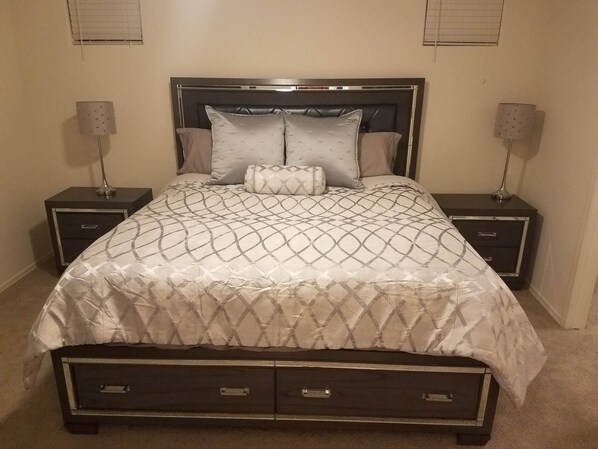 A neatly made bed with a patterned bedspread, two bedside tables with lamps, and a headboard. - 3Bed/3Bath GATED community CONDO w/ POOL,JACUZZI,FITNESS CENTER (Goodyear)
