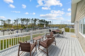 Relax on the deck with a view of the marina and boats docked.