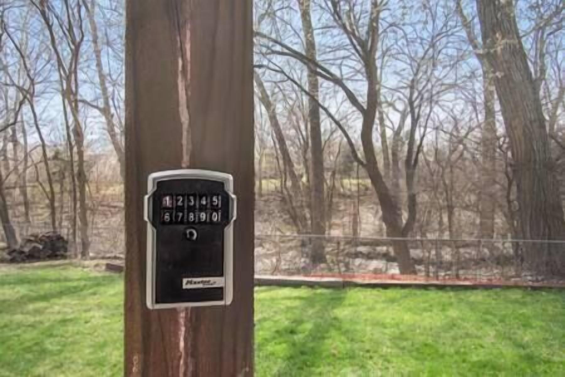 A keypad security lock on a tree trunk.