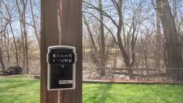 A keypad security lock on a tree trunk.