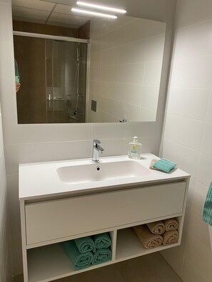 Shower, hair dryer, towels, toilet paper