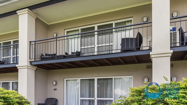 A multi-story residential building with balconies, large windows, and a clean facade. - Apollo Quays Apartment (Halls Head)