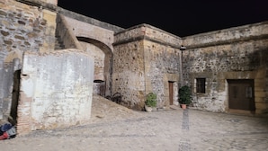 An ancient stone courtyard with arched doorways and a tiled floor. - Stunning Apartment With Pool Close to Estepona, ES (Manilva)
