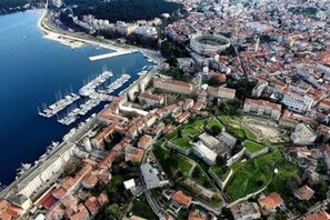 An aerial view of a coastal city with a marina, historic buildings, and a fortified area. - City Center Appartment Near Arena-pula (Pula)