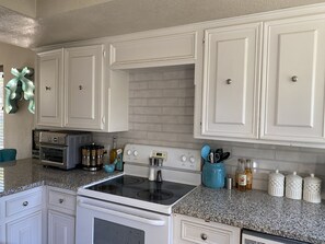 Microwave, dishwasher, coffee/tea maker, cookware/dishes/utensils