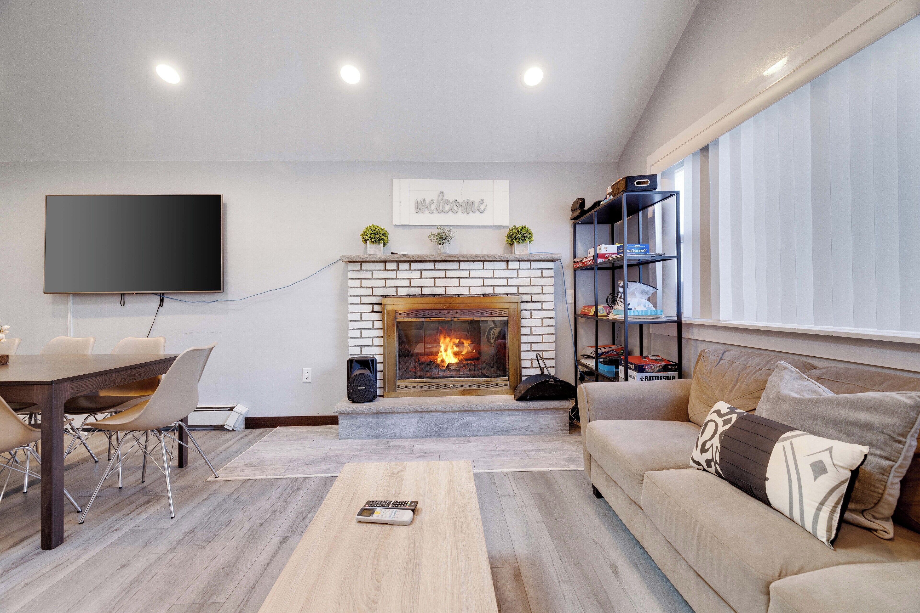 A living room with a fireplace, a flat-screen TV, a sofa, and a coffee table.