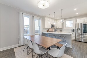 Enjoy cooking in this well-equipped kitchen with a central island, sink, and ample counter space.