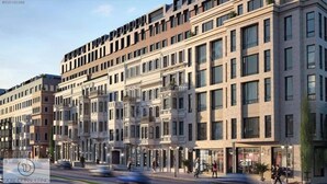Ein mehrstöckiges Hotel mit einer klassischen Fassade, großen Fenstern und einem zentralen Eingang mit Vordach.