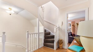 A staircase with white balusters leading to a landing. - Arcadia House - Close to Beaches, Harbour and Town (Tenby)