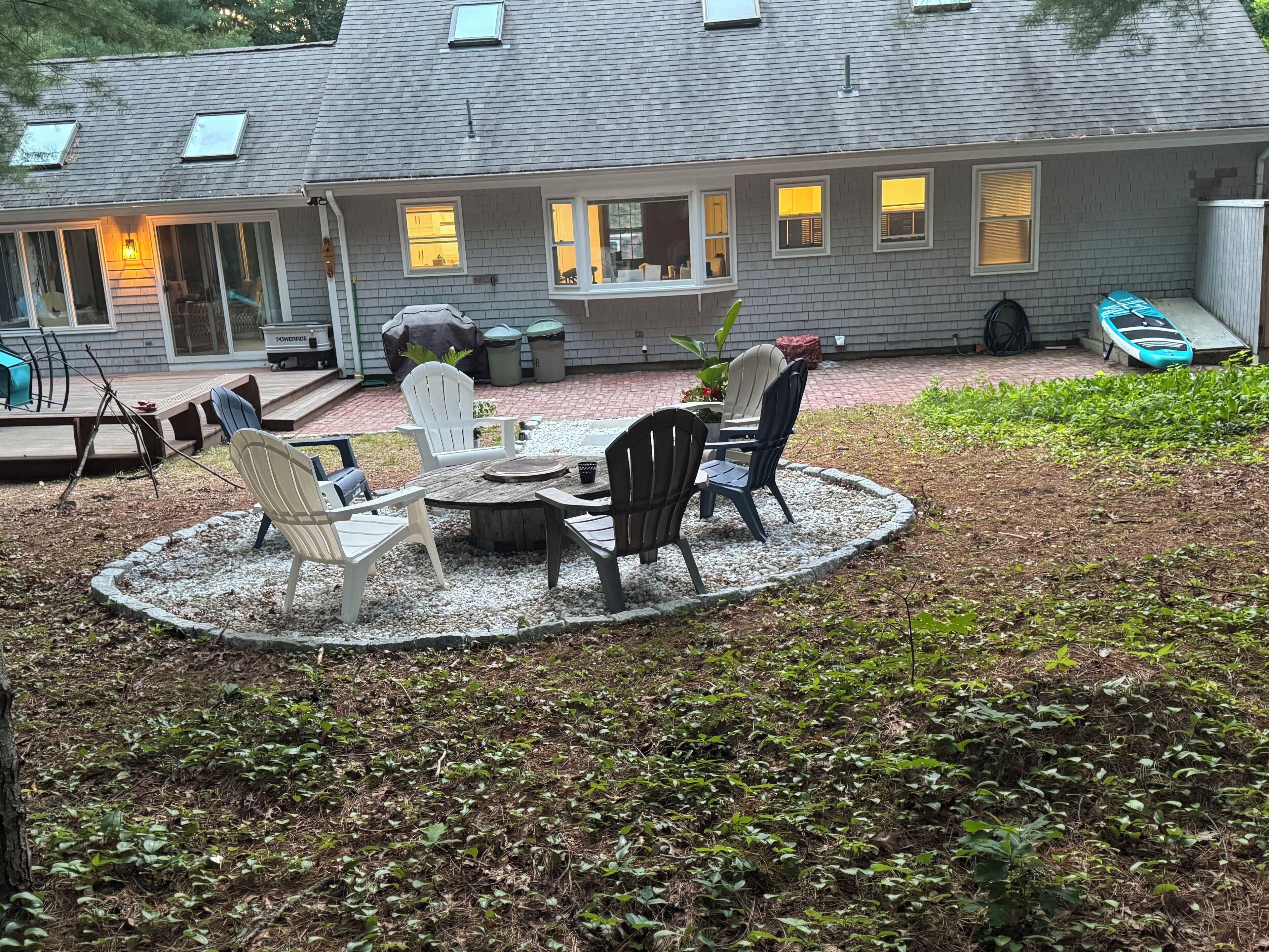 A house with a patio area featuring outdoor furniture and a covered seating area.
