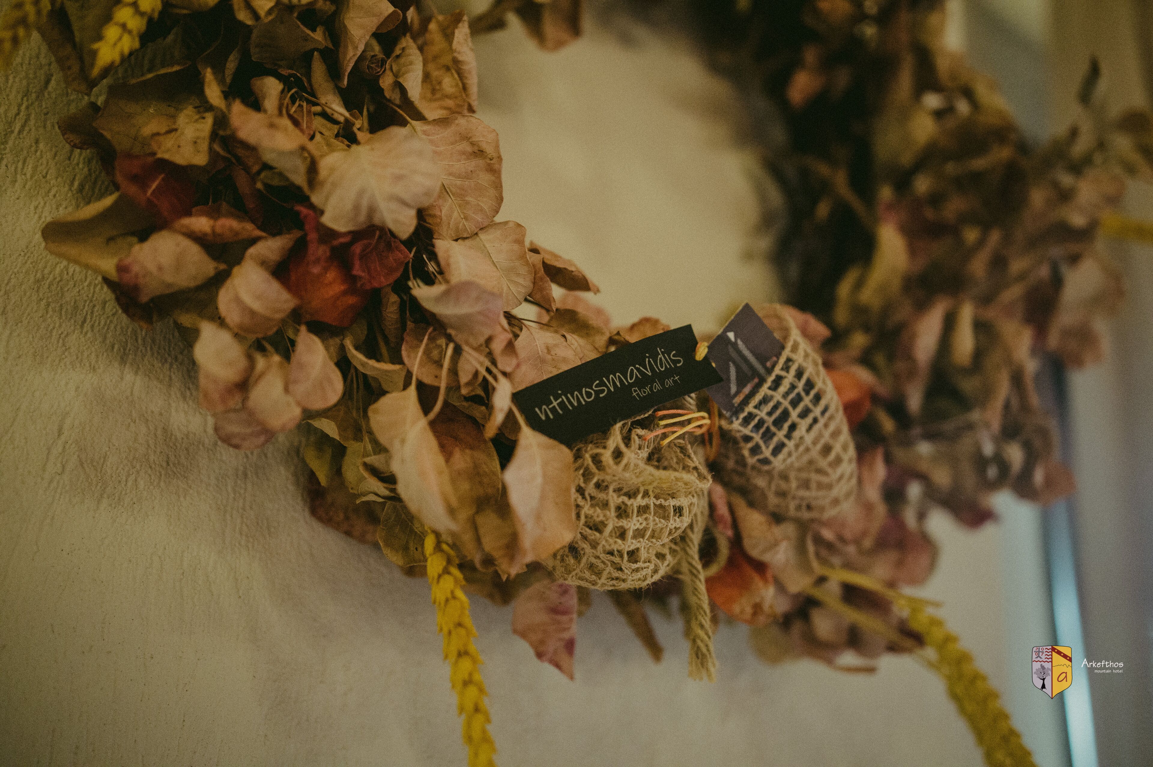Dried flowers arranged on a surface with tags, possibly for decoration or display.