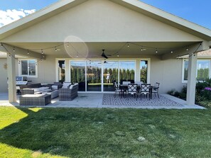 A covered patio with outdoor furniture, a grill, and string lights. - Elevated R & R in Desert Aire! (Desert Aire)