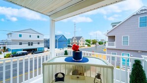 A balcony with a railing, a potted plant, and a small table. - Beautiful Lavallette Home - Perfect for Family and Friends (Lavallette)