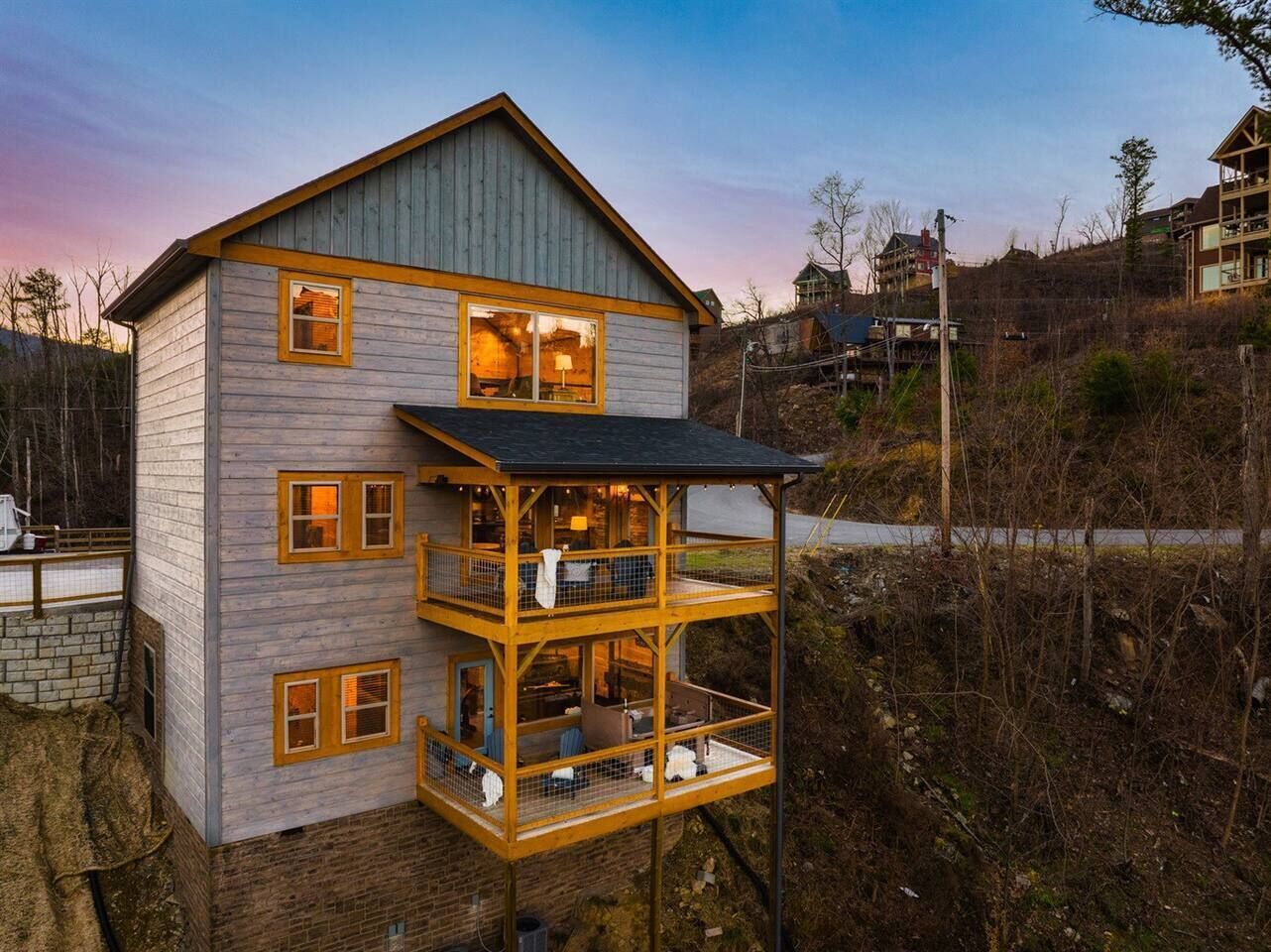 A two-story wooden house with a balcony on the ground floor.
