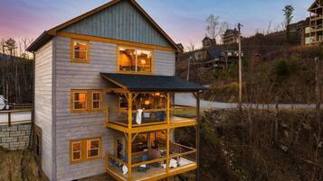 A two-story wooden house with a balcony on the ground floor.