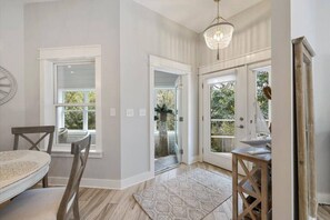 Enjoy meals in the dining area with a round table and chairs, surrounded by natural light and a beautiful view.