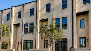 A multi-story brick building with uniform windows and a central entrance.