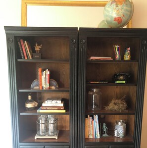 Bookcase with multiple shelves stocked with books and decorative items.