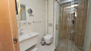 Shower, rainfall showerhead, slippers, towels