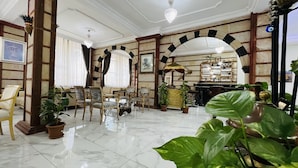 A spacious lobby with a marble floor, wooden furniture, and a reception desk. - Tas Saray Bardakci Hotel (Kahta)
