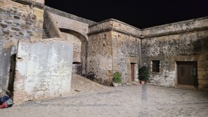An ancient stone courtyard with arched doorways and a tiled floor. - luxury apartments sea views with pool (malaga)