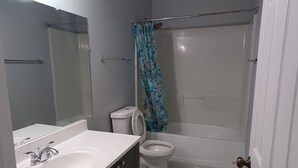 A bathroom with a white sink, toilet, and bathtub. - Relaxing Retreat Close to Everything! (Mesa)