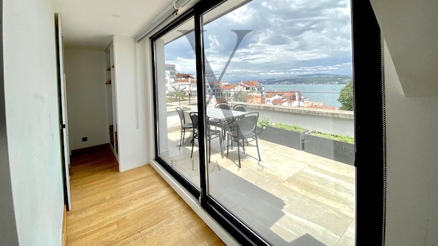 A room with a large sliding glass door leading to an outdoor patio with a table and chairs. - X Flats Taksim (Istanbul)