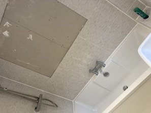 A bathroom with a bathtub, a shower, and a toilet.