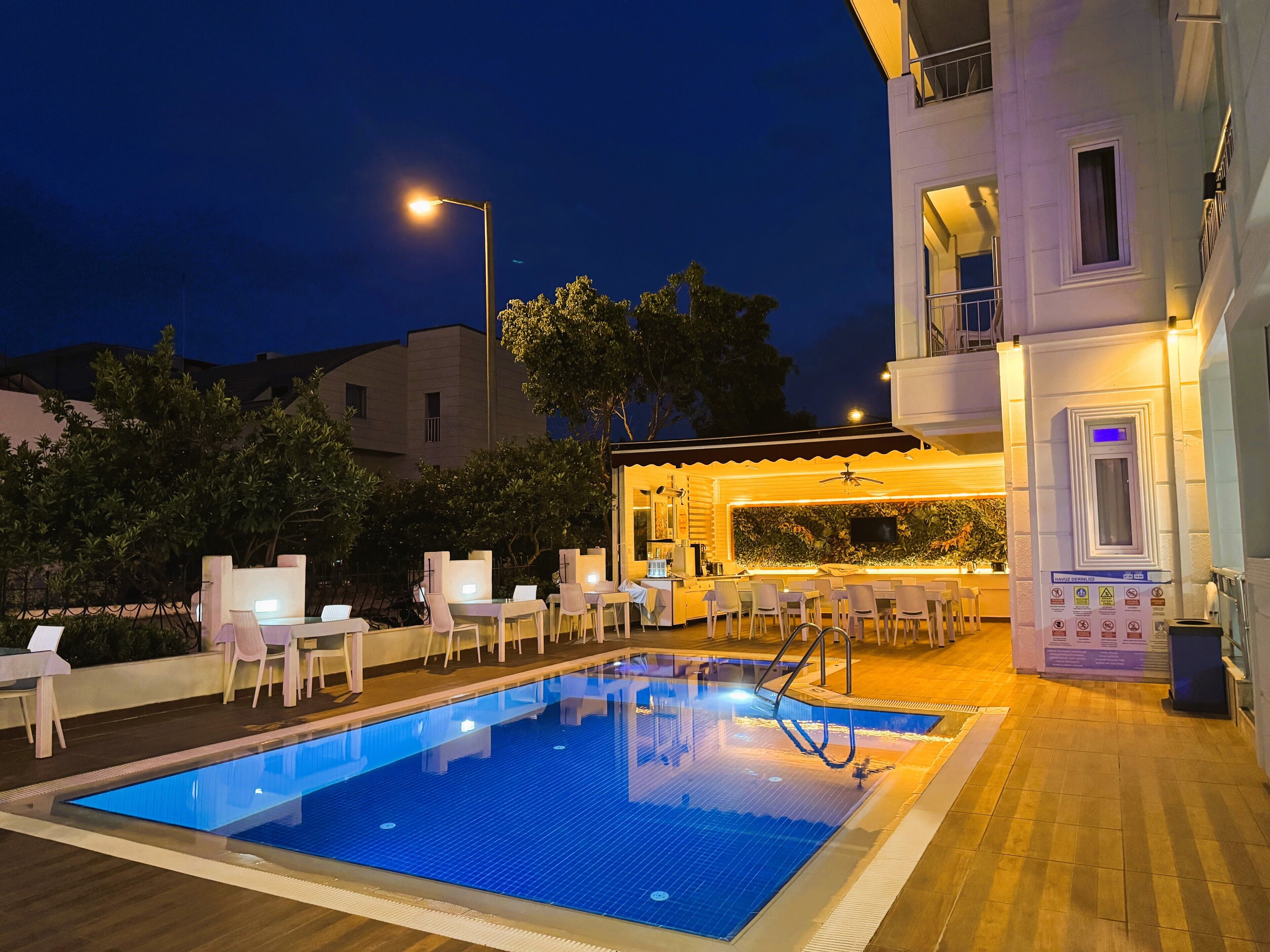 A swimming pool with lounge chairs and a bar area.