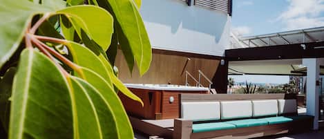 An outdoor seating area with a modern design, including a bench and a table.