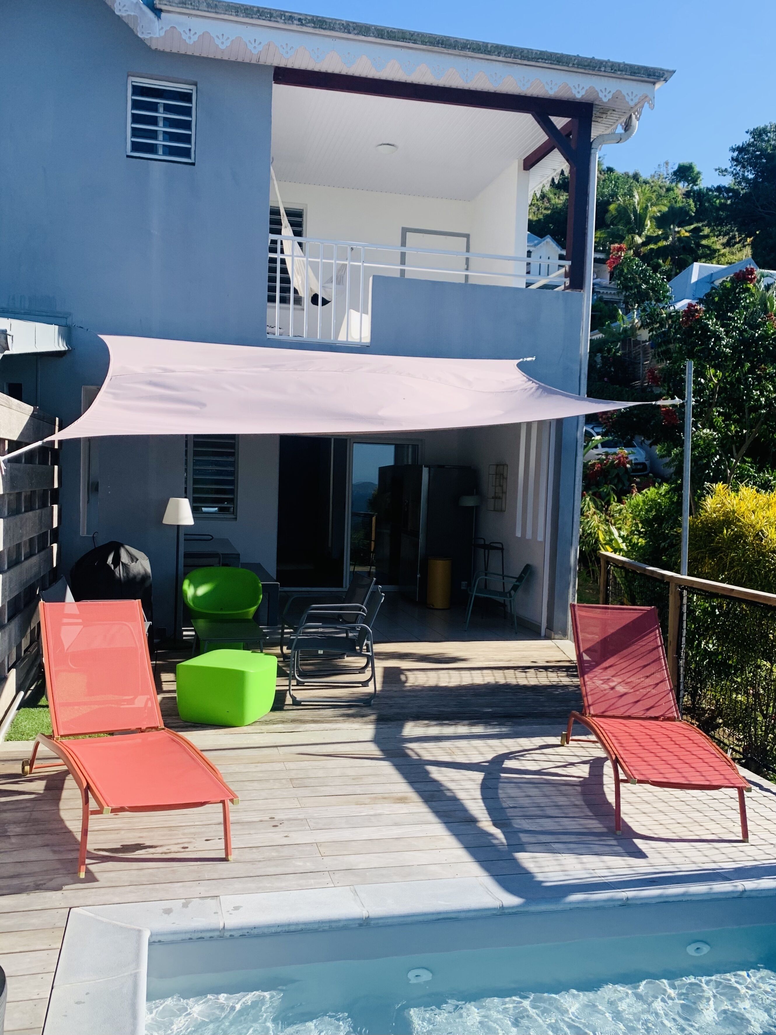 Une maison à deux étages dotée d’un patio couvert.