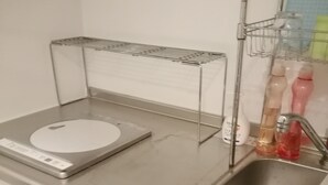 A kitchen with a stainless steel countertop, a sink, and a drying rack. - Only 1 minute to subway station (G-18 Ginza Line) (台東区寿)