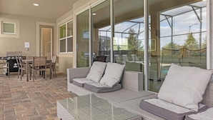 A covered patio area with a sofa, chairs, and a grill. - Luxury 9Beds Villas With Pool Spa In Solara (Four Corners)
