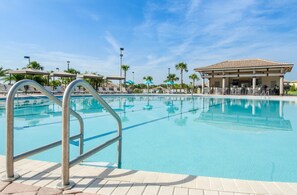 A swimming pool with a metal ladder, lounge chairs, and umbrellas. - Ultimate 6Br Villa W/Pool/Spa (9054SD) (Davenport)