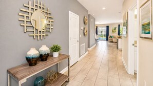 A hallway with a mirror, decorative vases, a potted plant, and a console table. - Luxury 9Beds Villa With Private Pool/Spa(1671MV) (Davenport)