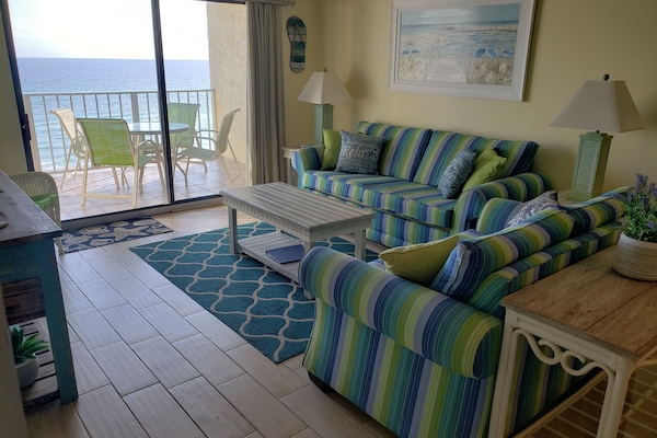 Bright and beachy open living area - couch is queen pullout