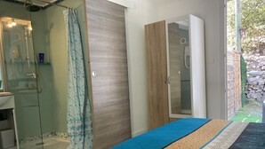 A bedroom with a bed, a shower, a wardrobe, and a bathroom. - Charming countryside home with a private garden (Le Beausset)
