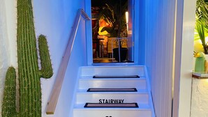A staircase with steps labeled "STAIRWAY TO HEAVEN" leading to a brightly lit interior space.