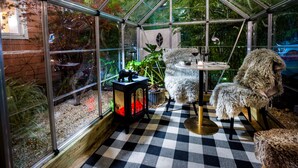 A greenhouse with a checkered floor, a table with a lamp, and a potted plant. - American Beech in Greenport - Two-Bedroom Apartment 8 (Greenport)