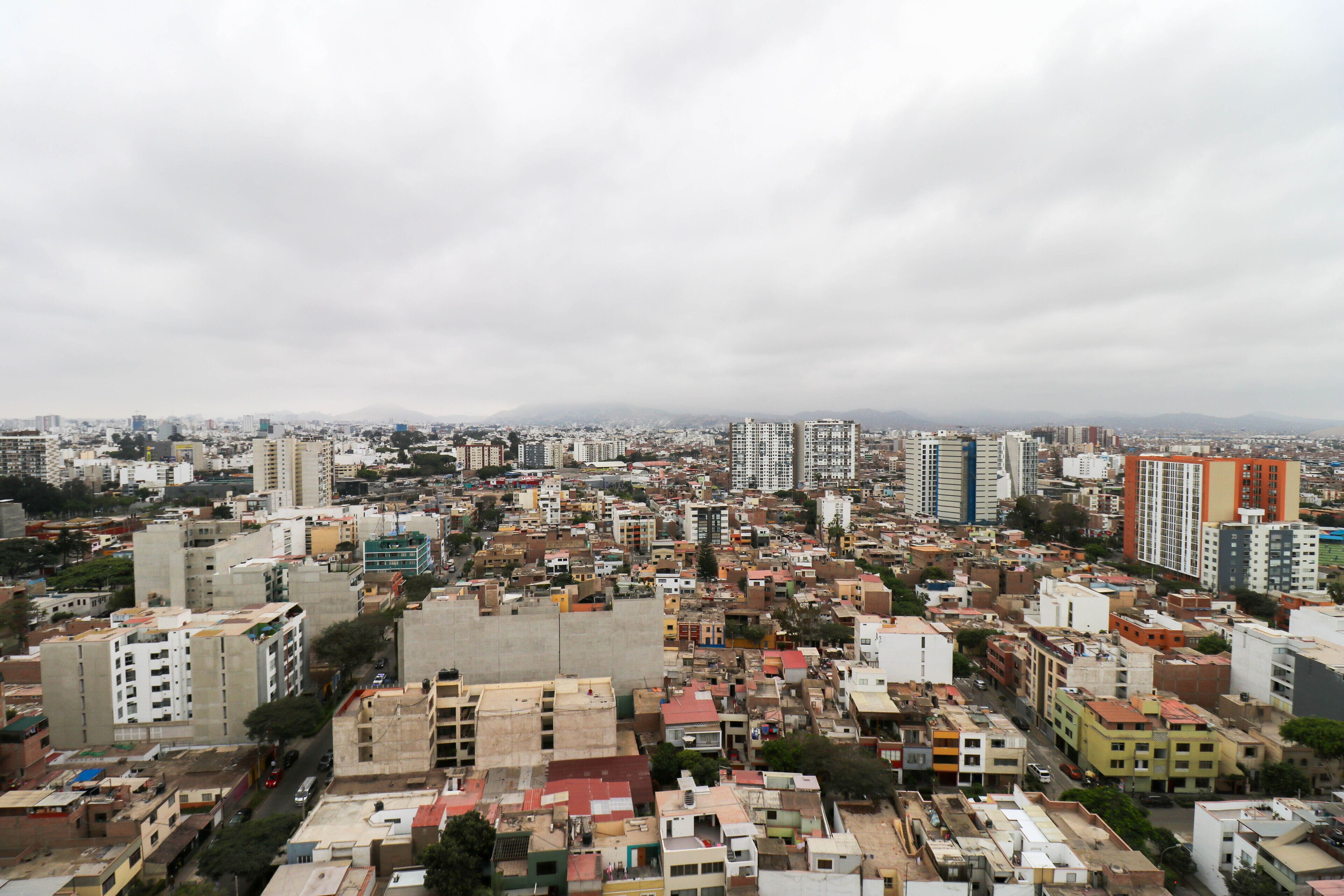 A densely packed urban area with a variety of building heights and architectural styles, including both residential and commercial structures.