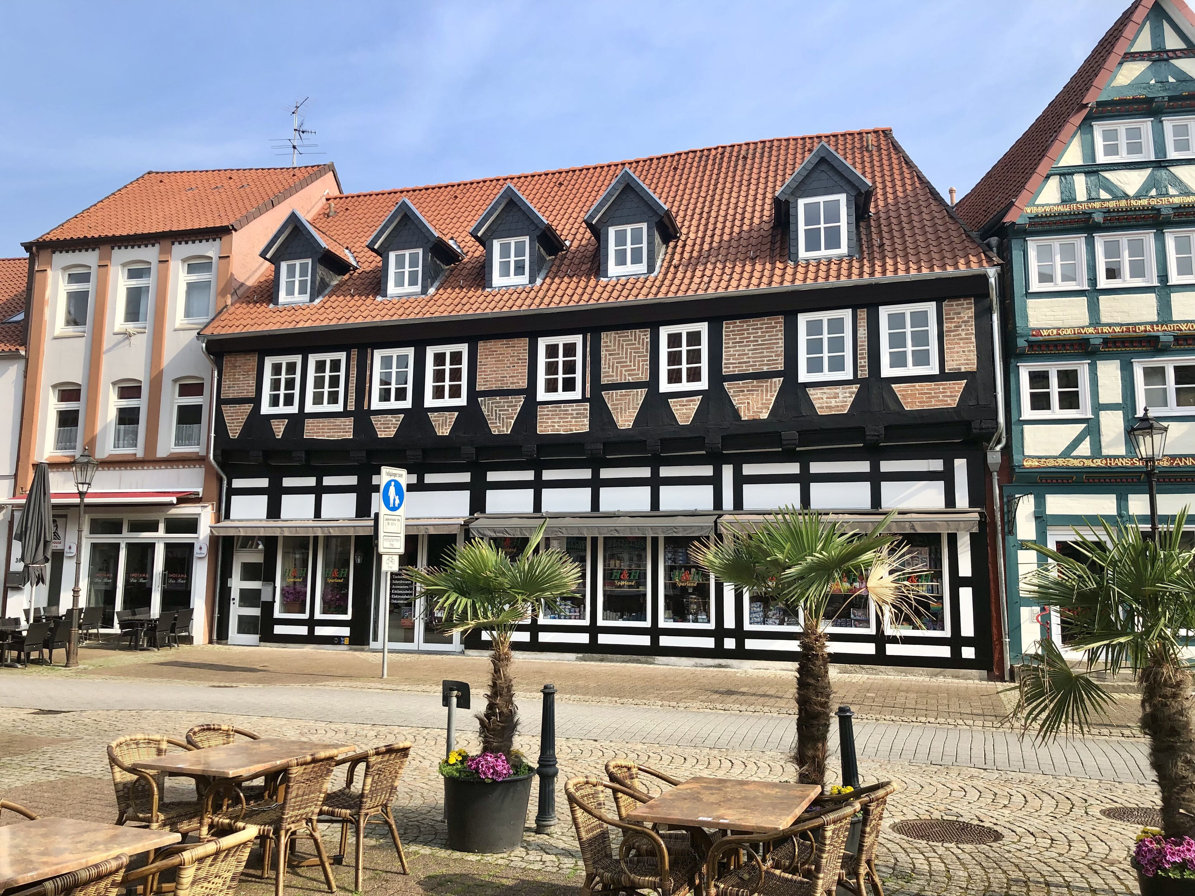 A traditional half-timbered building with a tiled roof and multiple windows.