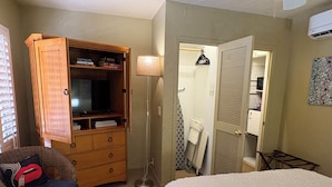 A bedroom with a bed, a wooden wardrobe, a floor lamp, a chair, and a closet. - 🌸Room 2️⃣ in a former boutique hotel, two blocks from Downtown Palm Springs 🌞 (Palm Springs)