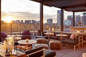 A rooftop lounge with outdoor seating, tables, and a city view. - Hyatt Centric Buckhead Atlanta (Atlanta)