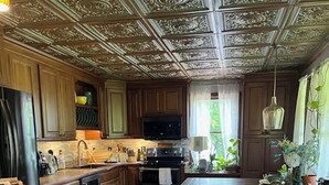 A kitchen with wooden cabinets, a central island, and a microwave. - Private Adirondack Getaway. Close to hiking trails, fishing, public beach. (Clemons)