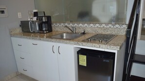 A compact kitchen with a microwave, coffee maker, and dishwasher. - Studio Apartment I Full Equipped I Lovely and Confort (Cabo San Lucas)
