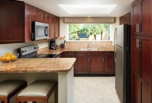 Enjoy cooking with a microwave, coffee maker, and sink with a window overlooking lush greenery.