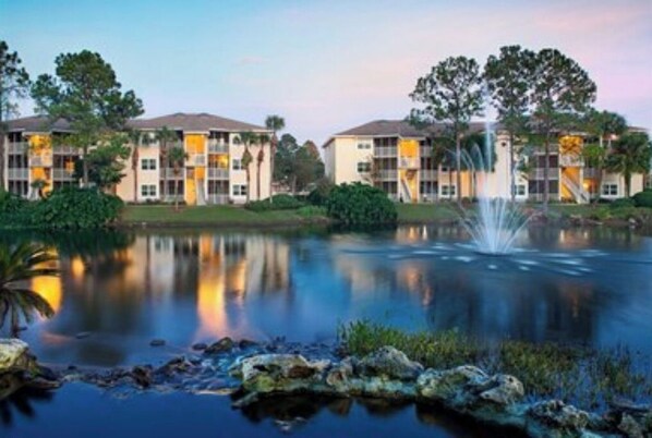 Surrounded by a serene lake, this hotel offers a tranquil retreat with a symmetrical design and picturesque views.