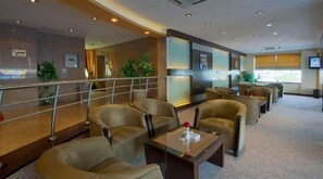 A hotel lobby with seating areas, a reception desk, and a large window. - Boudl Hotel Suites Salmiya (Salmiya)