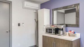 A kitchenette with a microwave, coffee maker, and storage cabinet. - Downtown Leavenworth King Studio - Parking + Balcony (Leavenworth)